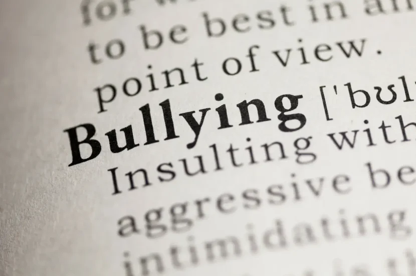Dictionary definition of "bullying" showing the word in bold with its meaning: "Insulting with aggressive behavior or intimidating.