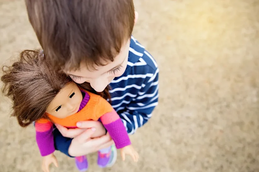 A Boy Hugging a doll