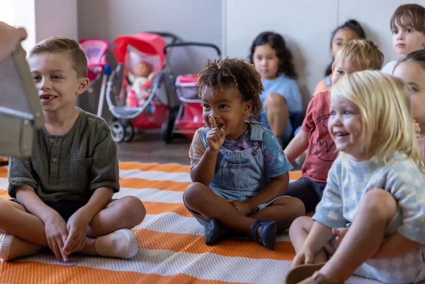 Group of young children sitting on a mat enjoying storytime at hey dee ho